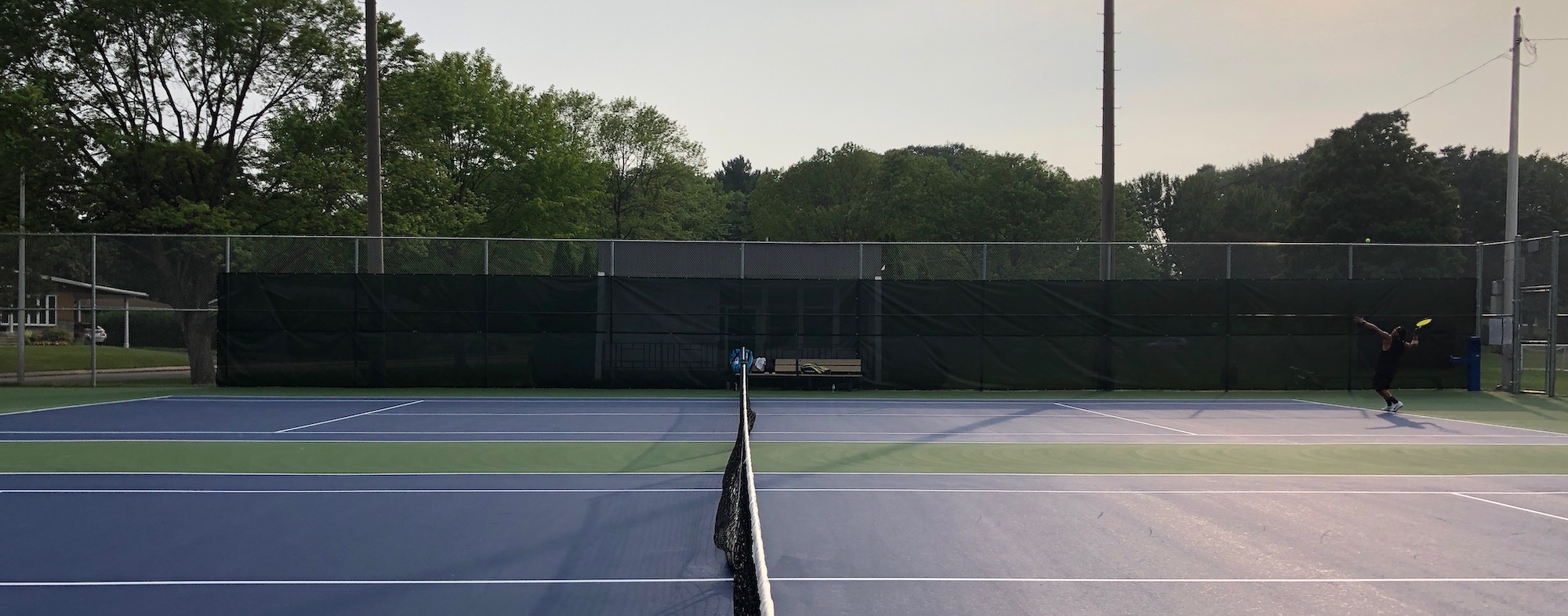 Tennis court with sun in the background